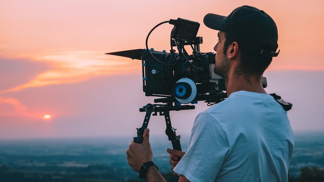 Person operating a professional video camera on a film set